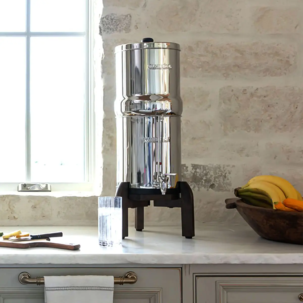 A Clearbrook stainless steel gravity water filter system on a kitchen counter
